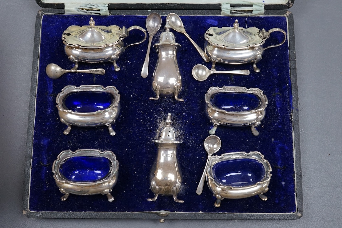 A George V cased eight piece silver condiment set, by Walker and Hall, Sheffield, 1912/1913, together with a group of assorted silver condiments and silver mounted toilet jars, etc.